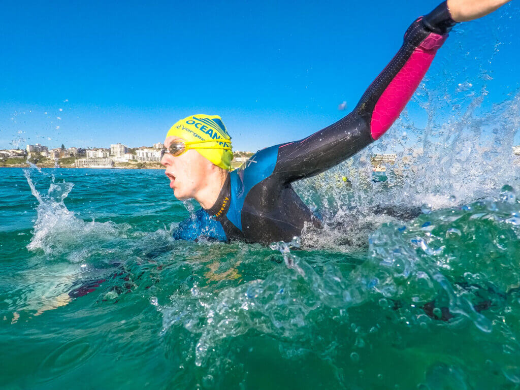 A swimmer wearing prescription swimming goggles in the ocean